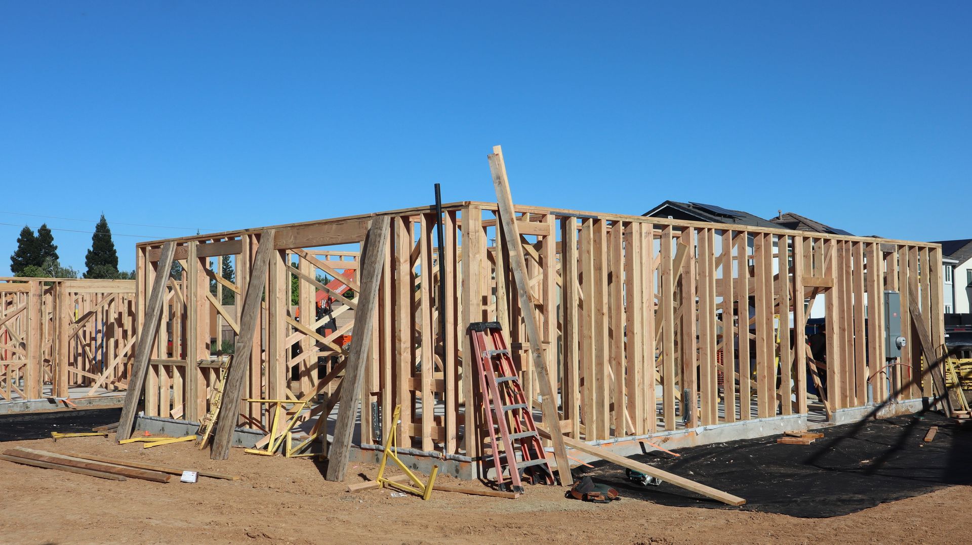 Framing stages of new home construction in sunny Elk Grove, California.