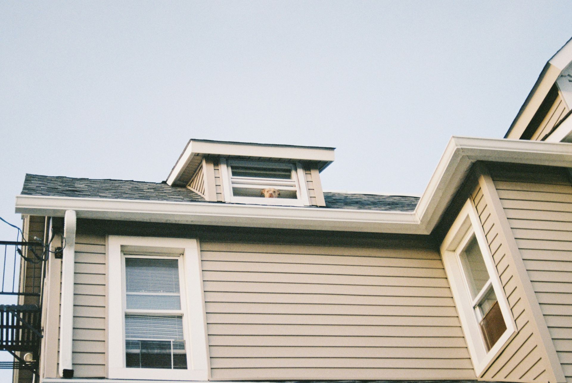 a house with a clock on the front of it